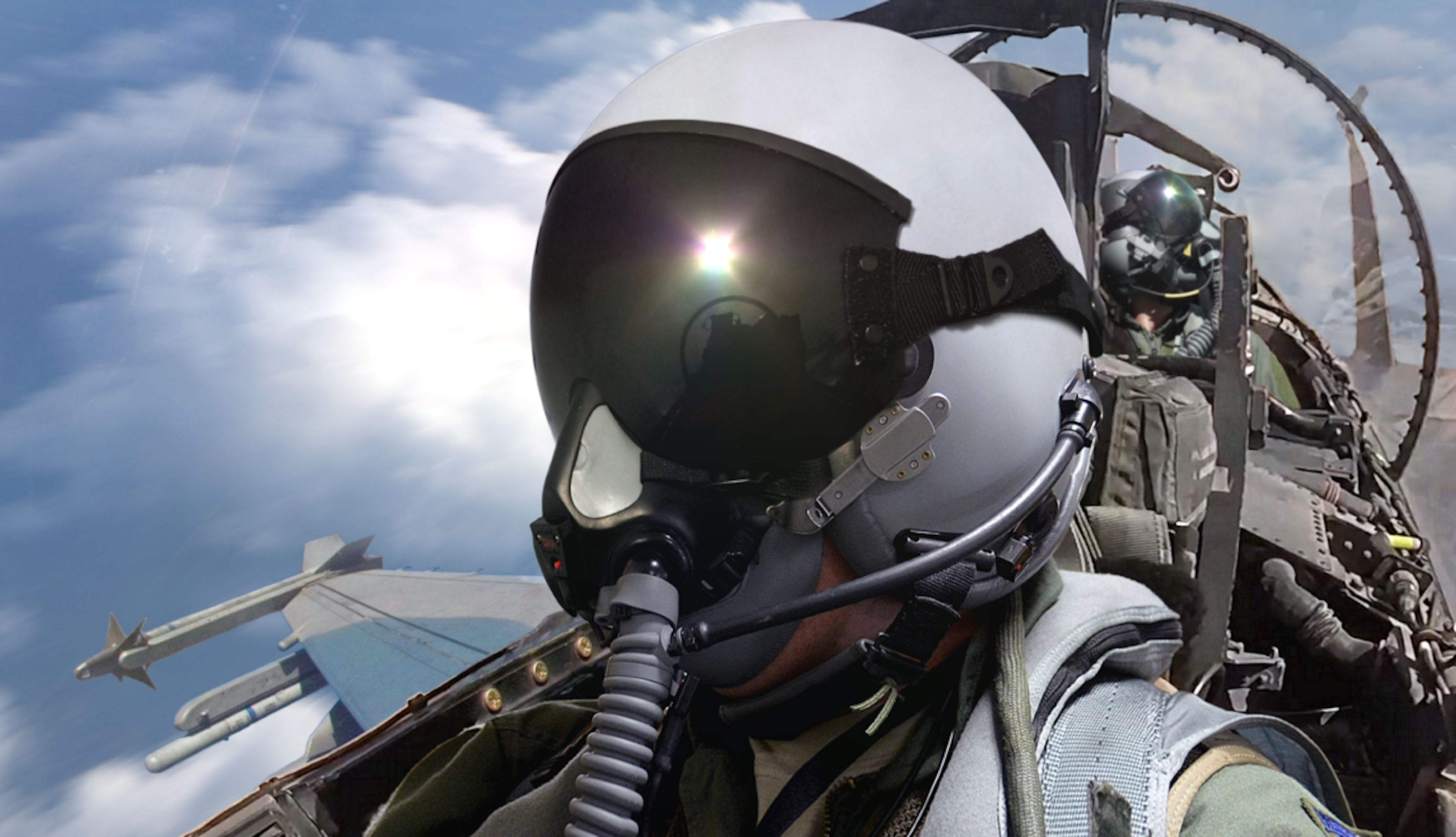 Close up on fighter pilot in cockpit of plane